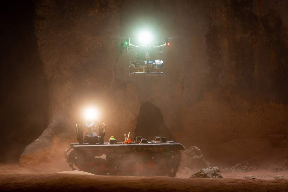 A drone and a robot in a cave.