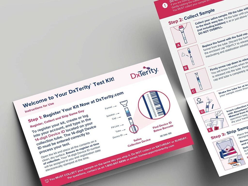 pink medical instruction cards of a covid test labeled dxterity