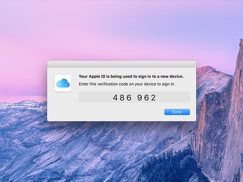 An Apple ID verification code on a macOS computer screen.