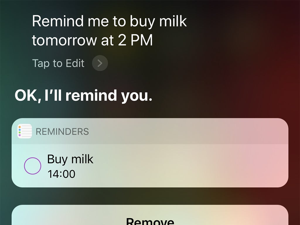 The iOS interface when you ask Siri to set a reminder to buy milk tomorrow at 2 p.m.
