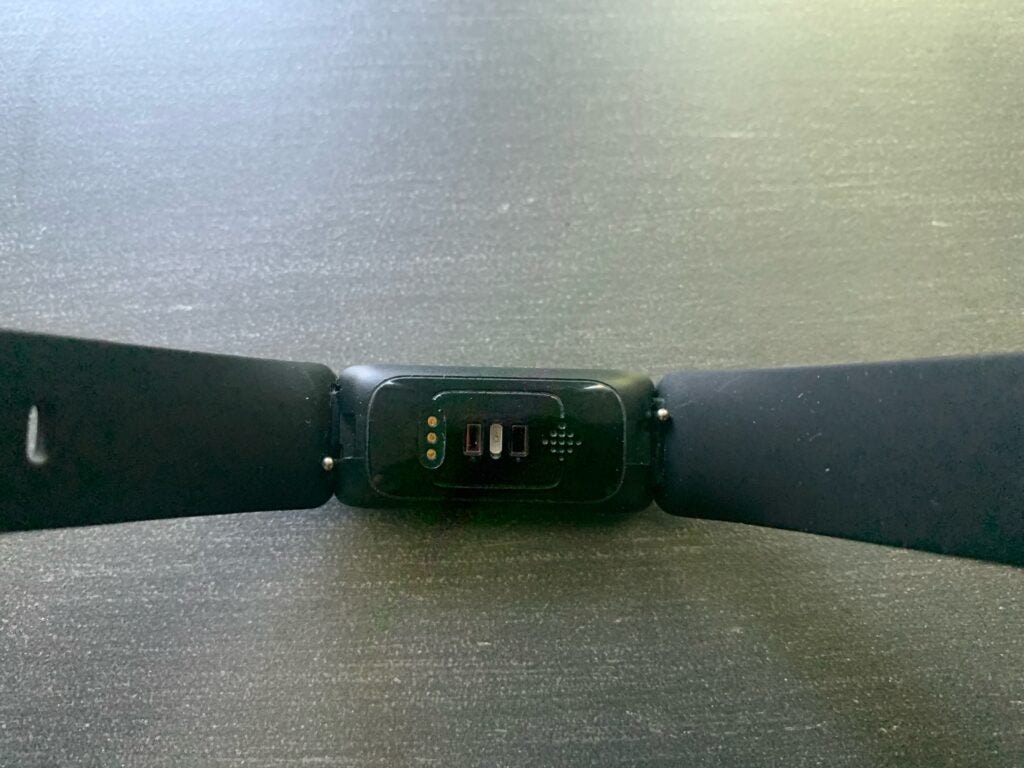 sensors on the back of a fitbit