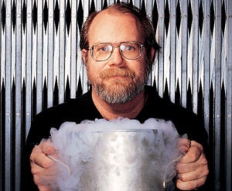 Chemist Theodore Gray holding a smoking steel vat