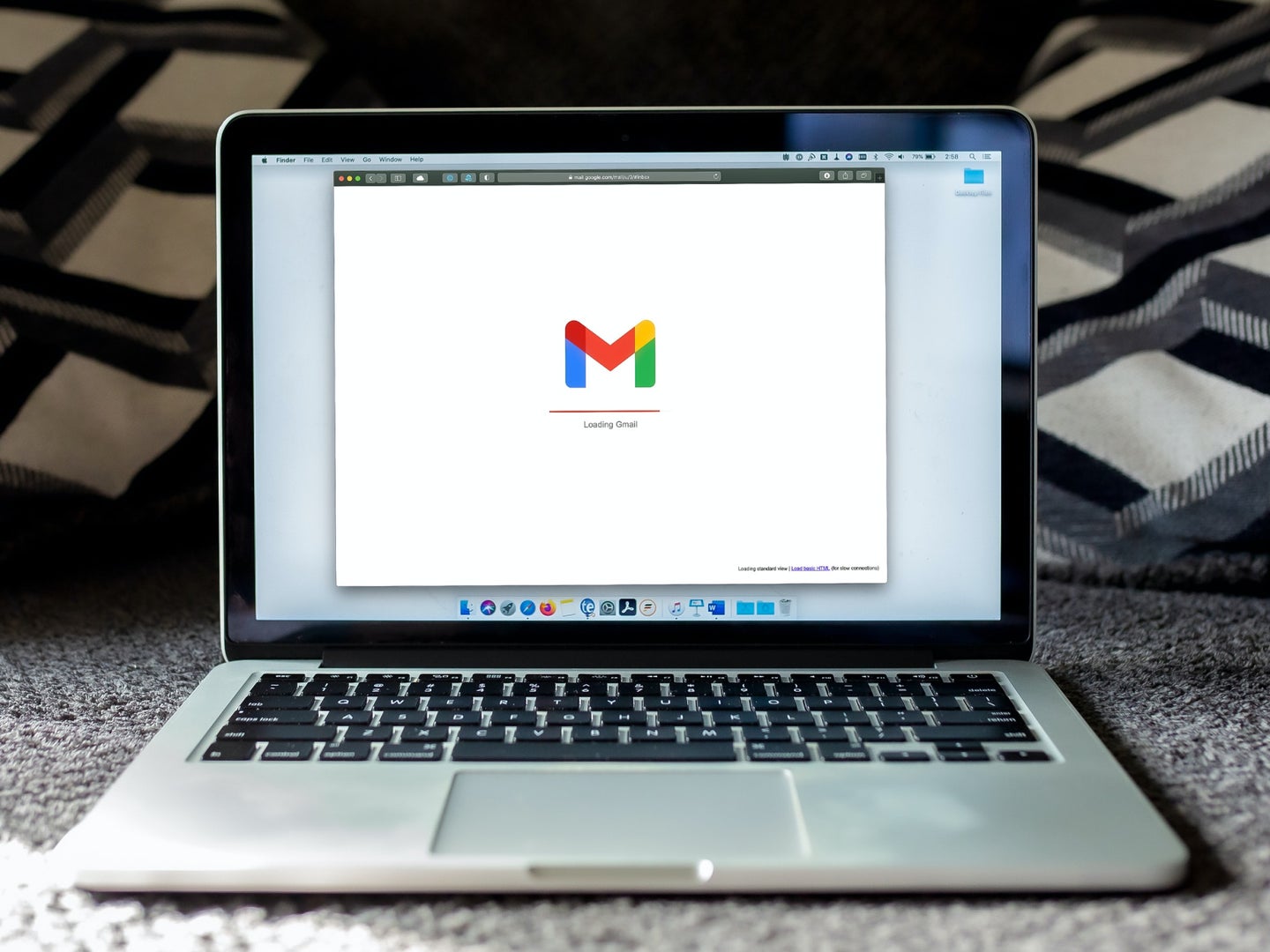 A Macbook laptop with Gmail loading in a browser. If you're lucky, you'll reach Inbox Zero in Gmail.