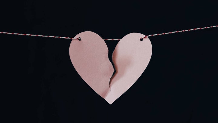 broken paper heart in clothline