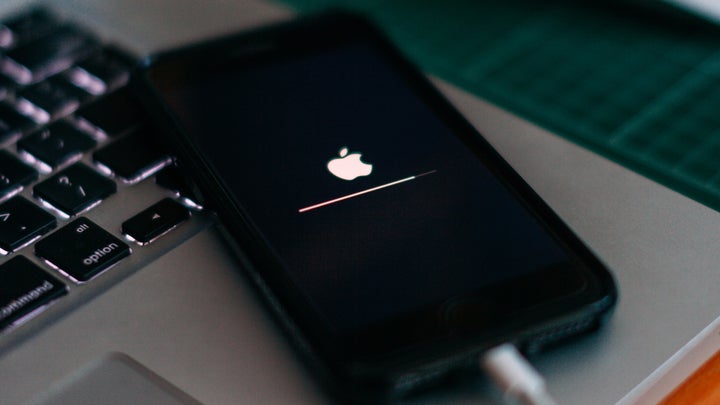 An iPhone plugged in and updating its software.
