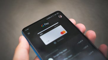 Google Pay on a smartphone screen in a person's hand