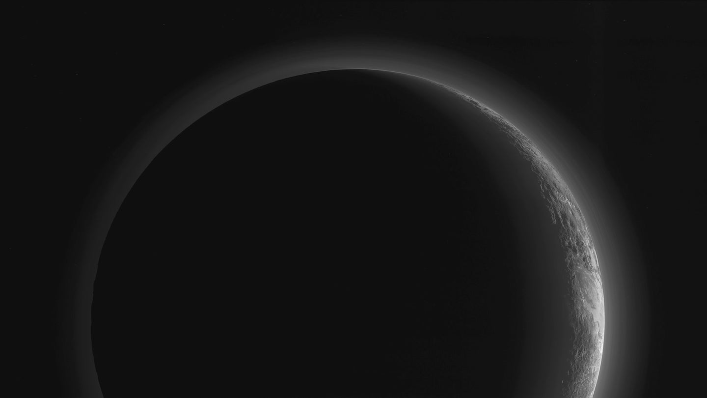 Pluto is not a planet but a dwarf planet. Outline of its corona on black taken by the NASA New Horizons probe.