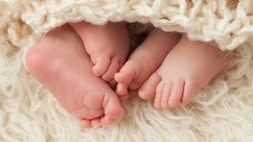 baby feet under blanket