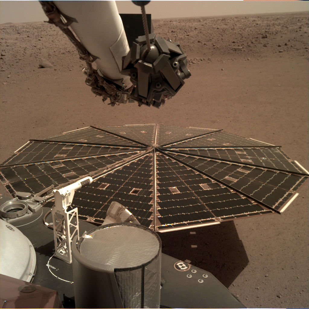 InSight's solar panel sits in front of a Martian landscape