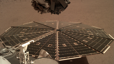 InSight's solar panel sits in front of a Martian landscape