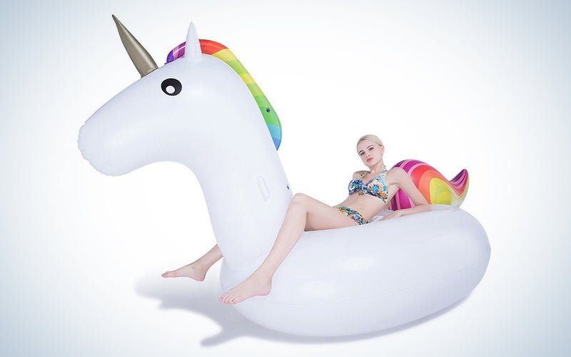 a girl on a unicorn pool float