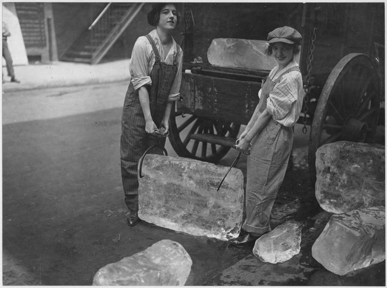 two women holding a block of ice