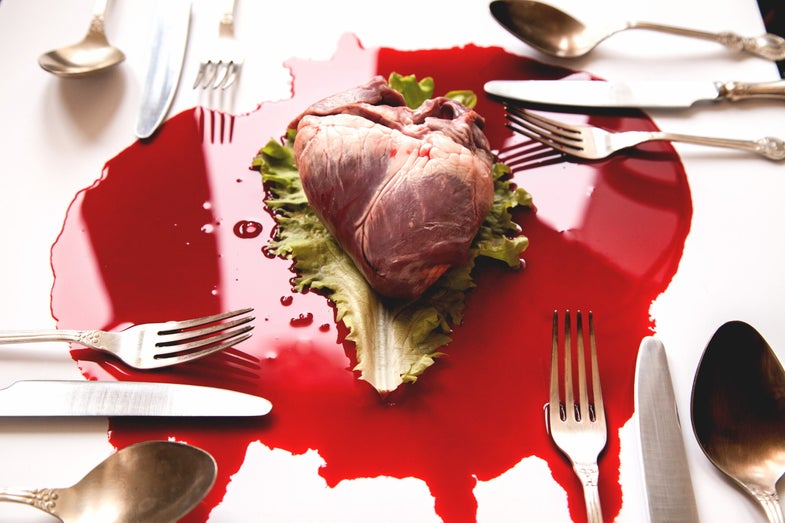 a bloody heart surrounded by forks