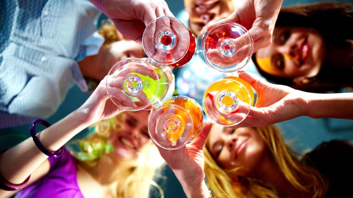 a group of people toasting wine glasses
