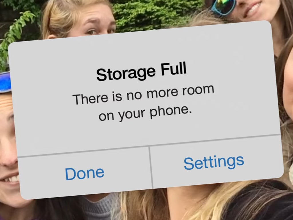 An iOS alert on an iPhone screen that says the storage is full and there is no more room on the phone.