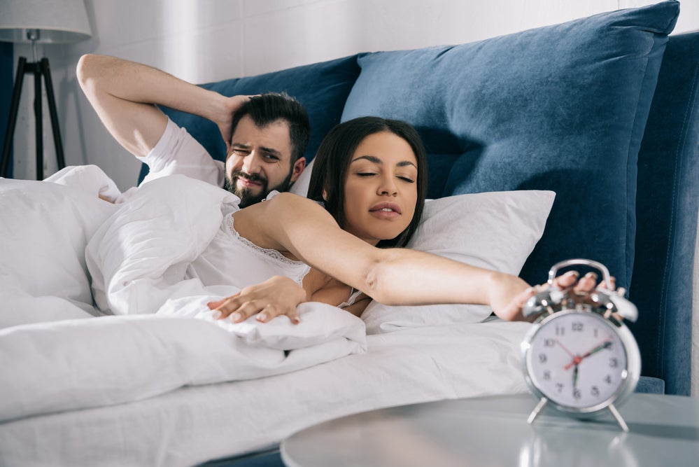 couple waking up to alarm