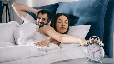 couple waking up to alarm