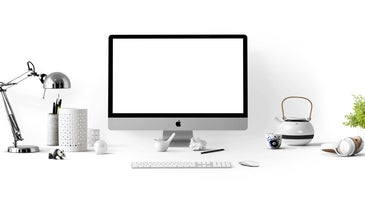 an Apple Mac computer on a desk against a white background