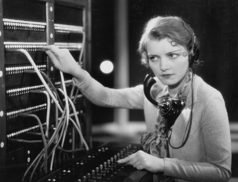 a woman at a switchboard listening
