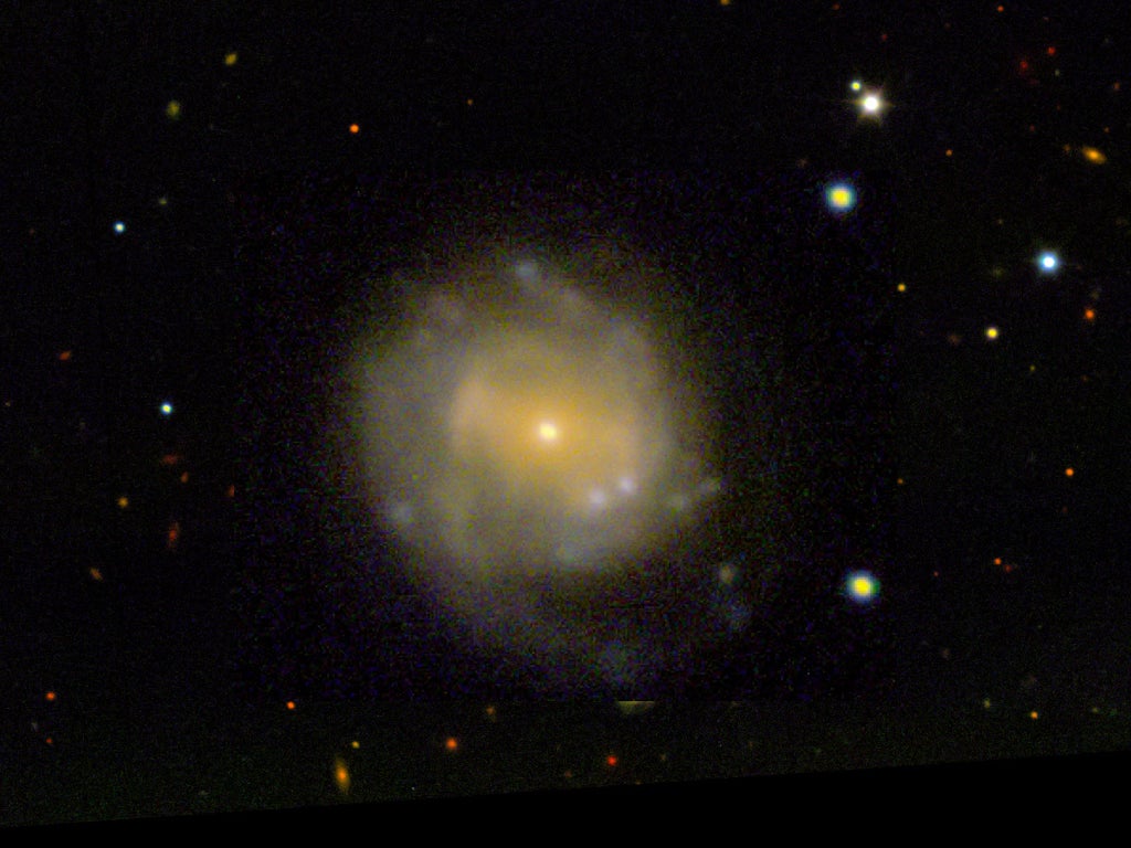 a picture of space with a large circular smear of yellow light at the center