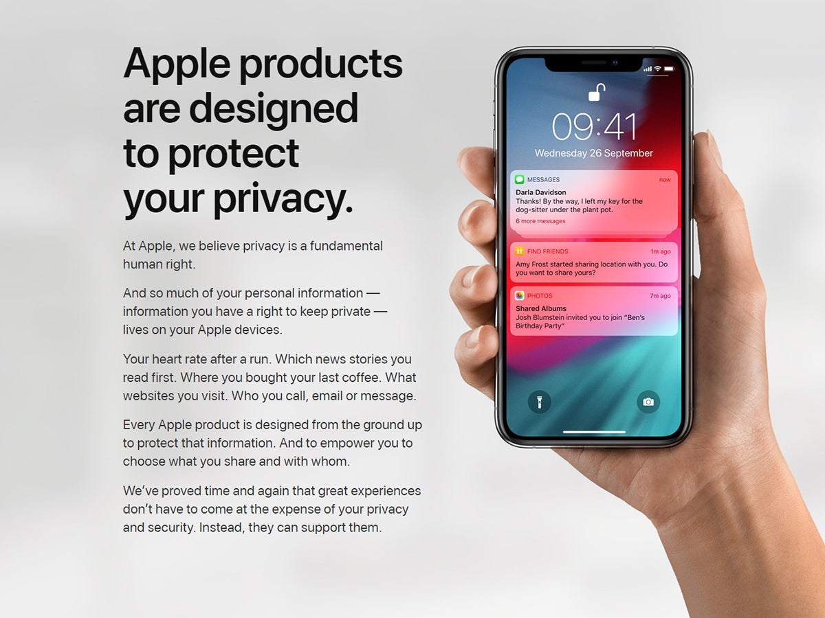 Apple's privacy mantra next to a hand holding an iPhone.
