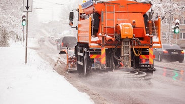 Snow plow Spraying salt onto roads