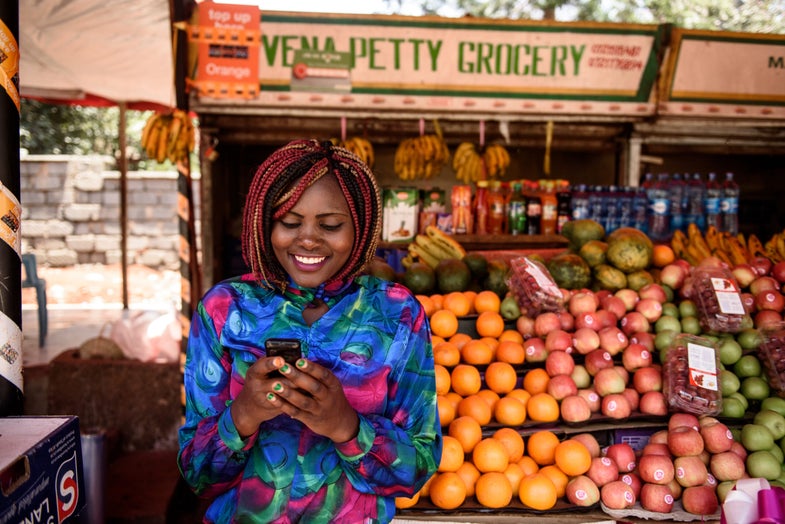 A business owner uses mobile money in Kenya.