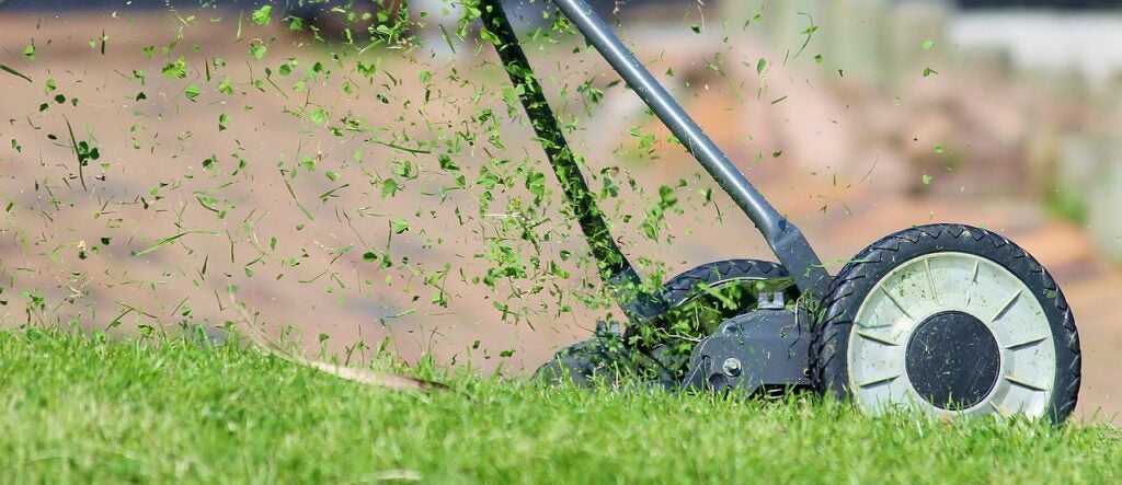 A push lawn mower cutting grass