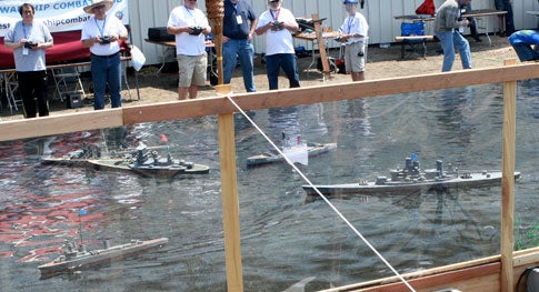 Remote-controlled model battleships fighting in a pool at Maker Faire 2008 in San Francisco.