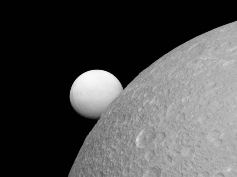 The Cassini probe circling Saturn just snapped this gorgeous <a href="http://gizmodo.com/enceladus-and-dione-look-stunning-in-the-latest-cassini-1743132398">shot</a> two of Saturn's moons: Enceladus (background) and Dione (foreground). Enceladus is half as large as Dione, but has enormous underwater oceans and ice volcanoes that make it a target for finding life in our solar system. Dione is much like our moon, a dusty planet covered in impact craters.