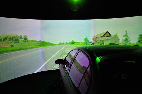 A pulled-back look reveals that most the visual work is done by a bending, panoramic screen and projector.