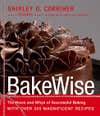 The cover of BakeWise by Shirley O. Corriher, showing a chocolate cake with a frilly chocolate topping.