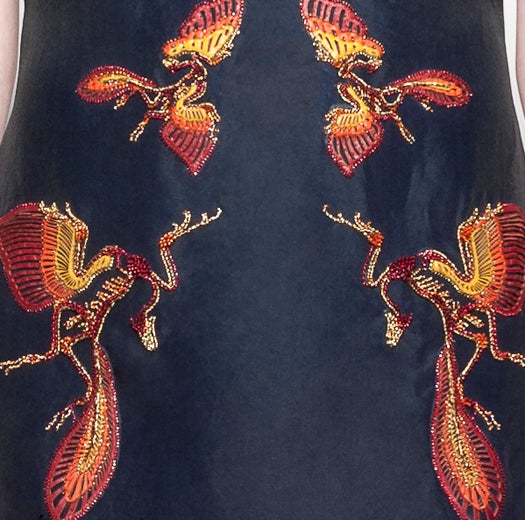 Detail from a gown with leather and beads depicting an a(r)chaeopteryx fossil. The fossils we've found of this species indicate that it was blue-jay- to chicken-sized and had claws. (Mathieu Mirano Spring/Summer 2013.)