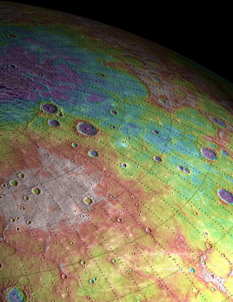 This perspective shows narrow, sinuous ridges on Mercury's northern portions, rendered in reddish color, which suggests the planet's volcanic plains were shaped by tectonic action. These are not quite mountain ranges — Mercury's surface is less varied than even the moon — but it indicates past tectonic activity. The white region is a high plateau, which also indicates broad deformation of the volcanic plains after they formed. The circular features are impact craters. Again, purple is low and white is high, in this case spanning a range of roughly 2.3 km (1.4 mi). The chunk of Mercury seen here is about 1,200 km (745 mi). Each line of the map overlaid onto Mercury represents 5 degrees latitude and longitude.