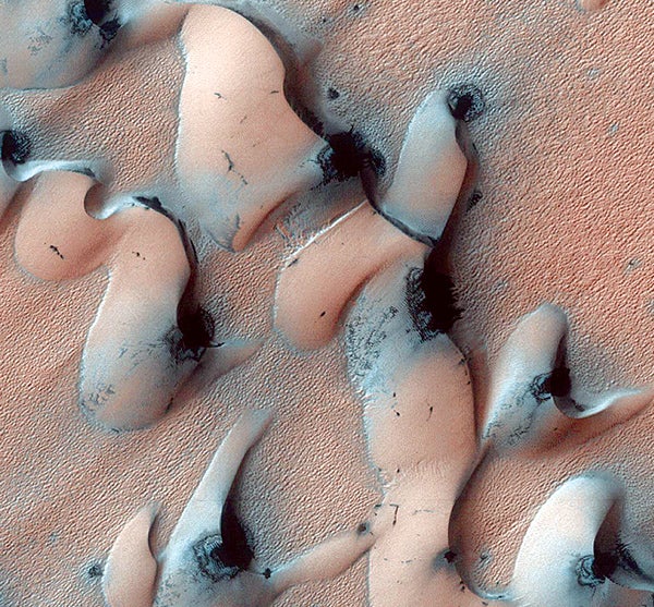 A region of dunes, shown in these three photos, lies near the northern polar ice cap. Each Martian winter, temperatures plummet to –225°F and polar ice caps made of solid carbon dioxide form. When spring arrives and temperatures rise to as high as 65°F, the ice cap evaporates without ever becoming liquid, a process called sublimation. The outlying crescent-shaped dunes [left], which were formed by wind blowing from south to north, defrost by the same process.