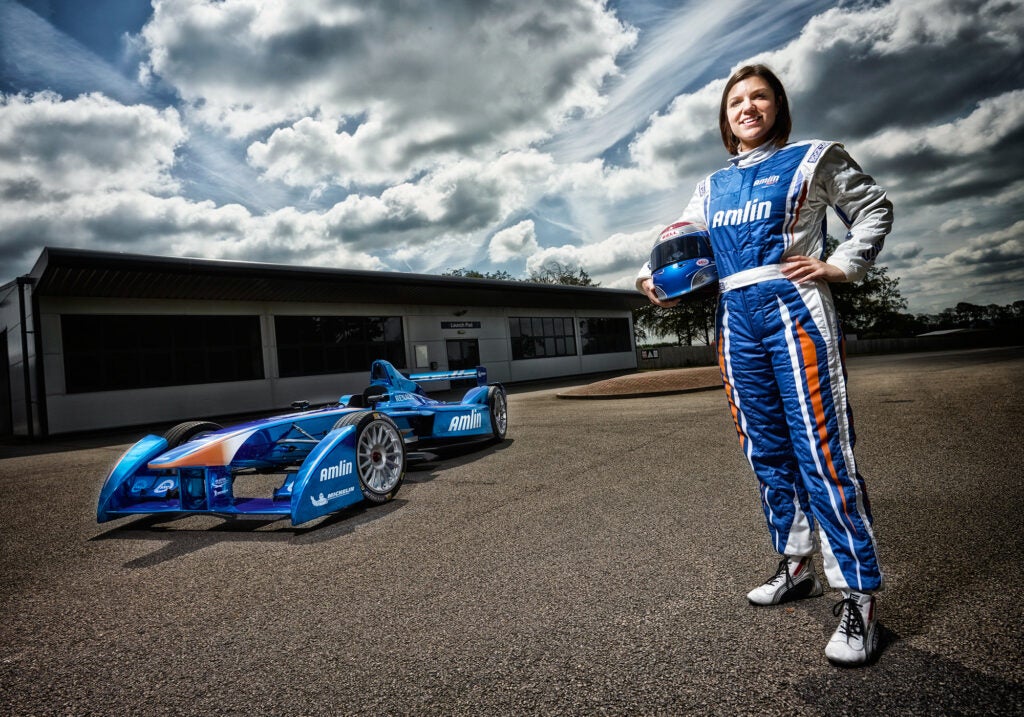 Katherine Legge stands in front of her Formula E racecar.