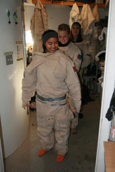 Crew members get suited up for the day's EVA outing. Front to back: Raechel Harnoto, California Polytechnic State University; Clara McCrossin, Shepherd University; and Mary Beth Wilhelm, Cornell University.