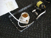 A light bulb socket and a motor with a propeller inside a bracket on top of black grid paper.