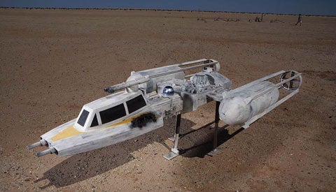 A homemade Star Wars Y-wing fighter rocket in the desert.