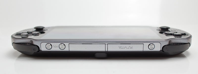 The top edge of the Vita hosts the power/lock button (it works just like the power/lock button on a smartphone), the slot for games or memory cards (that's the one labeled "PSVITA"), a hinge covering some various A/V and USB ports, and the volume buttons.