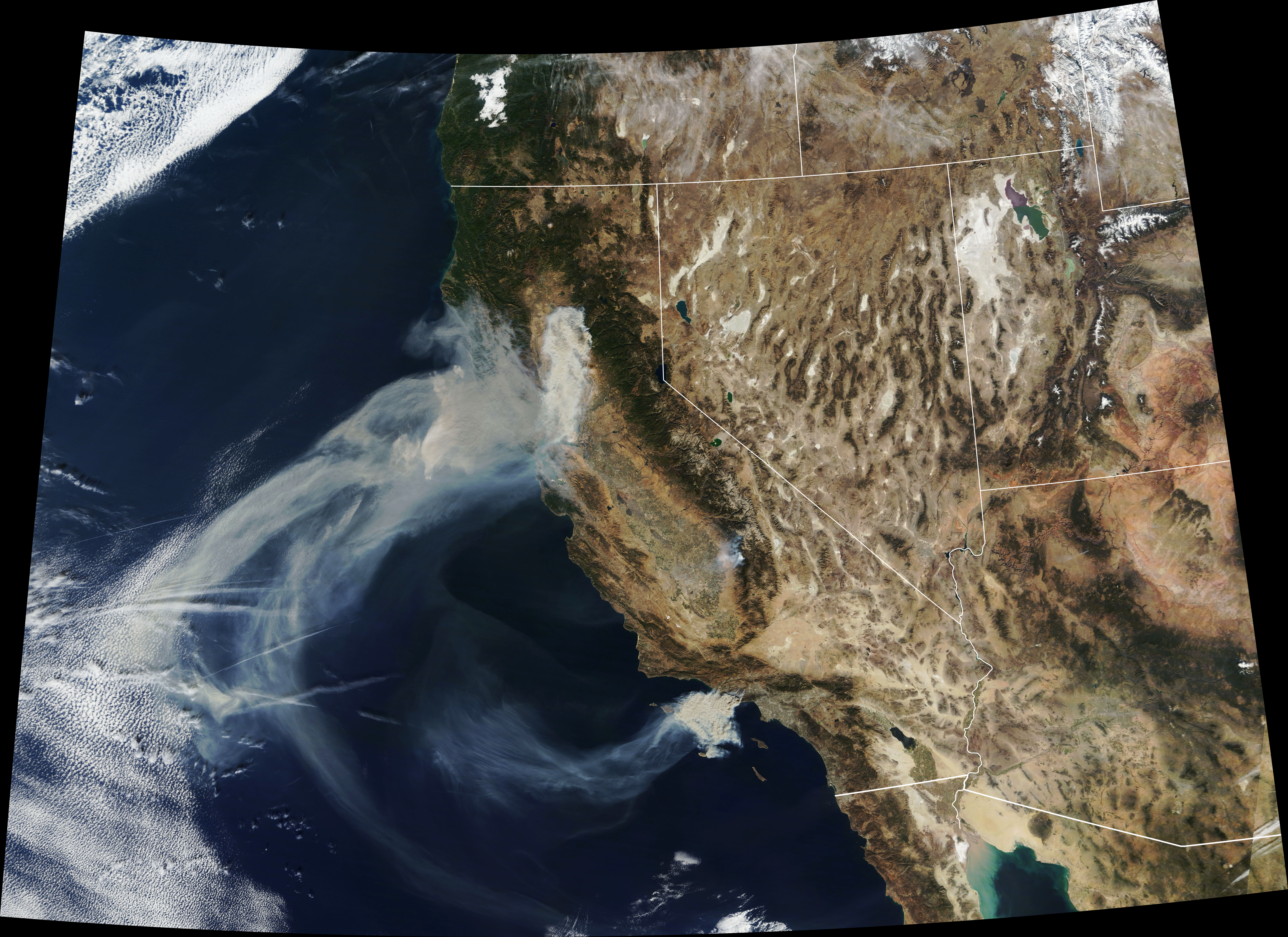 a satellite view of wildfires in california, with smoke blowing into the ocean