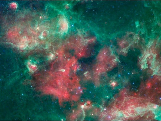 Captured in infrared by NASA's Spitzer Space Telescope, <a href="http://www.nasa.gov/mission_pages/spitzer/multimedia/pia15253.html">this image</a> of Cygnus X (part of the constellation Cygnus, or the Swan) is made beautiful by massive stars that have blown huge bubbles in the gas and dust in the region. This rather violent process causes both star birth and star death--and makes for a really nice image. Since the human eye can't see light in these wavelengths, the colors have been assigned to make them visible to us. The shortest wavelengths are blue, the longer red, and the mid-range light is green.