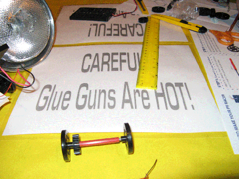 Building toy cars can be dangerous. Watch out for the hot glue and sharp knives.