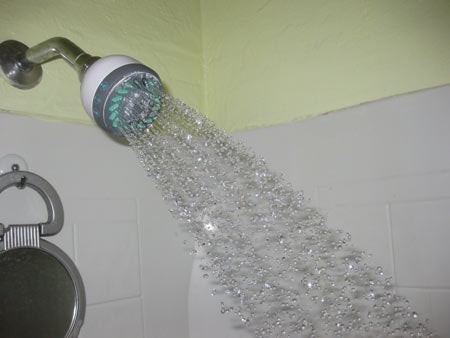 A shower head spraying water.
