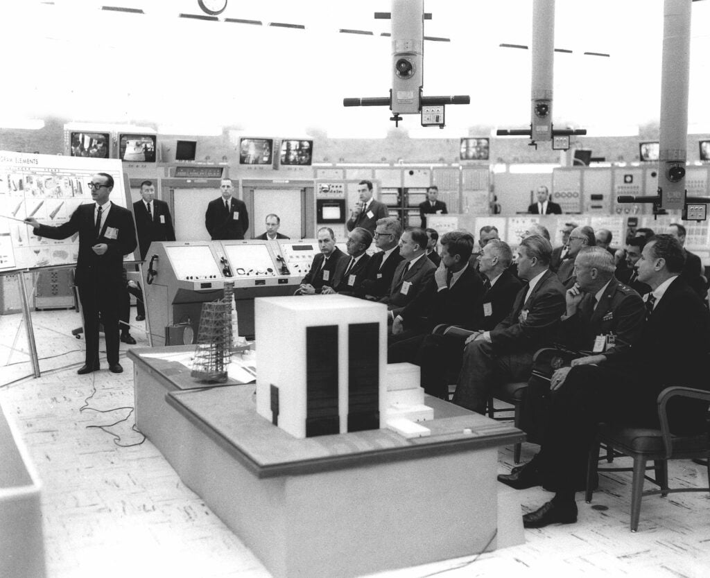 Dryden, on Kennedy's left, during a 1963 Apollo program presentation.