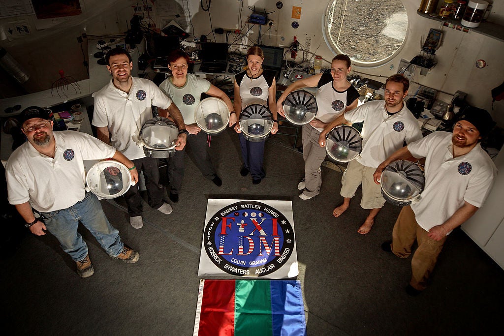 Astronauts around the flag