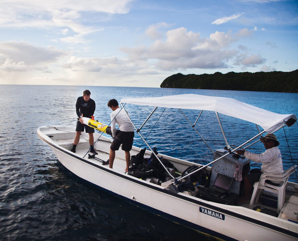 Eric Terrill [left] and Billy Middleton of the Scripps Institution of Oceanography prepare to launch a Remus autonomous underwater vehicle in Palau's western lagoon.
