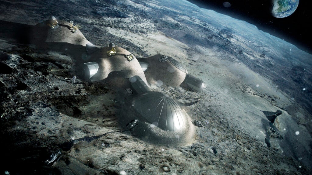 Once assembled, robots cover the inflated domes with a layer of 3D-printed lunar regolith to help protect the occupants against space radiation and micrometeoroids.