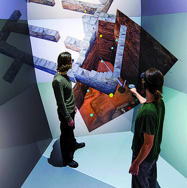 Students in a virtual-reality room walk through a Jordanian dig site.
