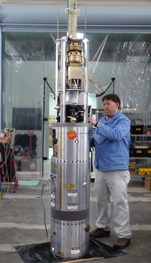 VISIONS Project Scientist Doug Rowland stands next to the payload during the final days of testing